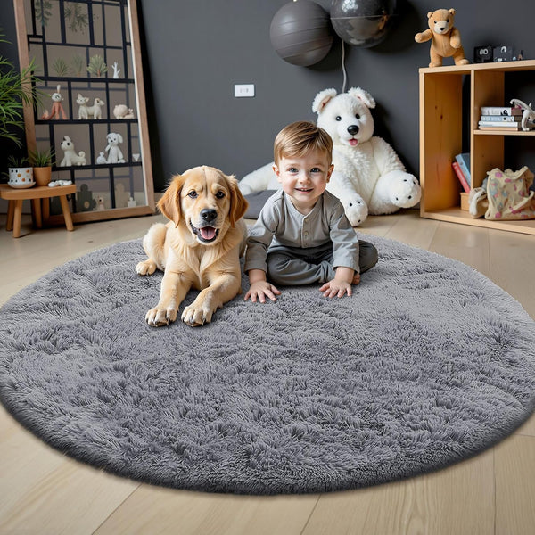Child and dog on a gray round rug in a room with toys and decor.