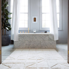 Orryn ivory textured hand tufted wool rug in a modern room