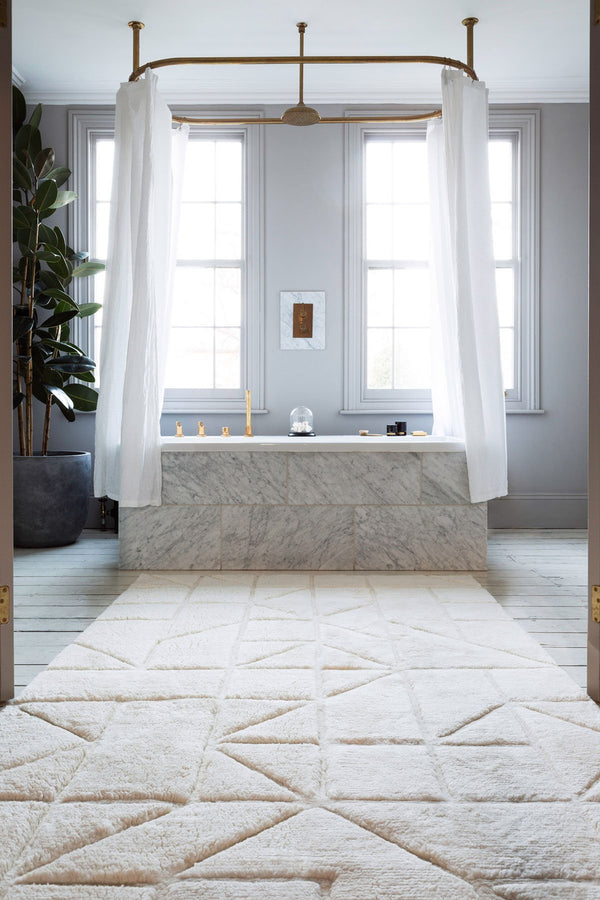Orryn ivory textured hand tufted wool rug in a modern room