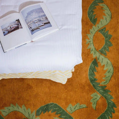 Coco orange floral border rug in a bedroom