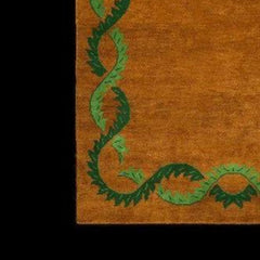 Close-up of Coco orange wool rug with green botanical border