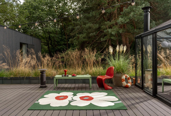 Petalia green floral wool rug outdoor patio with a rug featuring a large flower design lifestyle view 