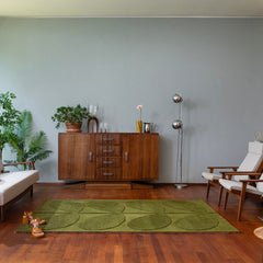 Tropical green leaf wool rug in a modern living room